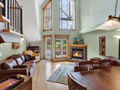 307-155 Crossbow Place, Canmore, AB - Indoor Photo Showing Living Room With Fireplace