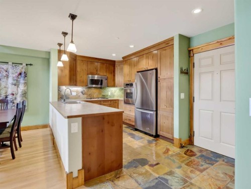 307-155 Crossbow Place, Canmore, AB - Indoor Photo Showing Kitchen With Stainless Steel Kitchen