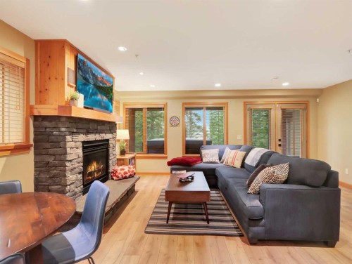 11-137 Wapiti Close, Canmore, AB - Indoor Photo Showing Living Room With Fireplace
