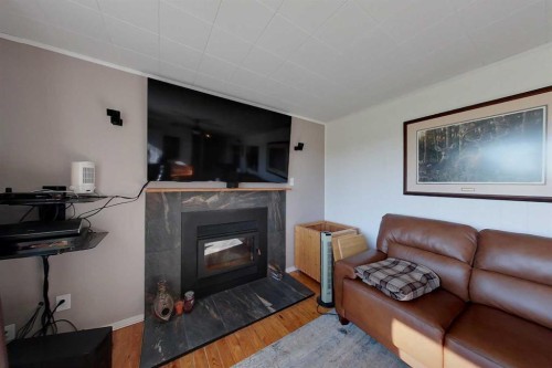 734041 Range Road, Wagner, AB - Indoor Photo Showing Living Room With Fireplace