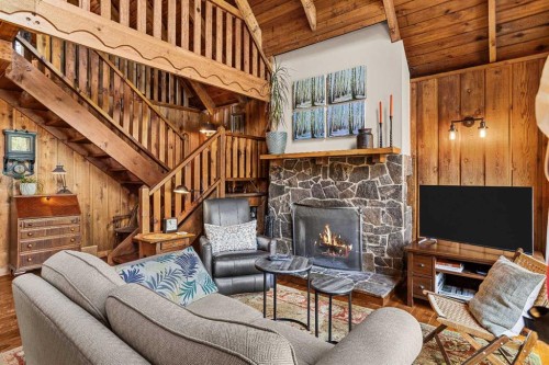 10 Heart Road, Lac Des Arcs, AB - Indoor Photo Showing Living Room With Fireplace