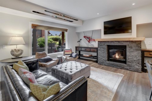 107-707 Spring Creek Drive, Canmore, AB - Indoor Photo Showing Living Room With Fireplace