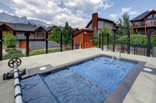 107-707 Spring Creek Drive, Canmore, AB - Outdoor With In Ground Pool