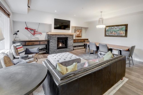 107-707 Spring Creek Drive, Canmore, AB - Indoor Photo Showing Living Room With Fireplace
