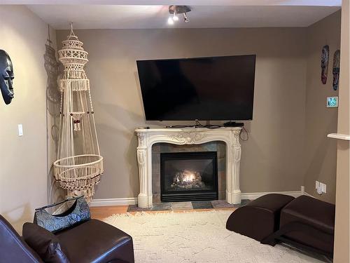 Unit 1-360 4 Street West, Drumheller, AB - Indoor Photo Showing Living Room With Fireplace