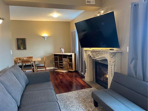 Unit 5-360 4 Street West, Drumheller, AB - Indoor Photo Showing Living Room With Fireplace