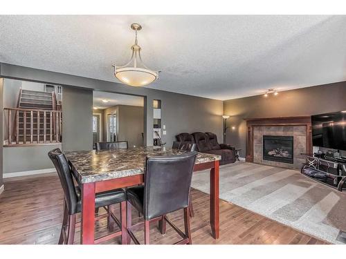 117 Seagreen Manor, Chestermere, AB - Indoor Photo Showing Dining Room With Fireplace