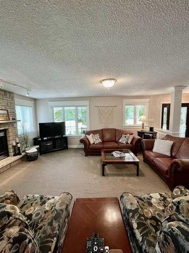24 Evergreen Park Close West, Brooks, AB - Indoor Photo Showing Living Room With Fireplace
