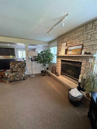 24 Evergreen Park Close West, Brooks, AB - Indoor Photo Showing Living Room With Fireplace