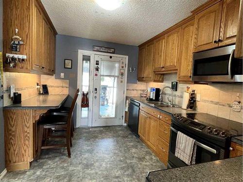 9 Spruce Drive, Drumheller, AB - Indoor Photo Showing Kitchen With Double Sink