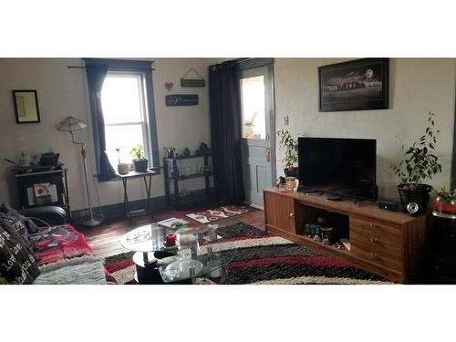 120 Main Street, Michichi, AB - Indoor Photo Showing Living Room With Fireplace