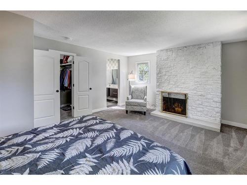 150 9 Street Nw, Drumheller, AB - Indoor Photo Showing Bedroom With Fireplace