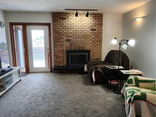 1422 Mccrimmon Drive, Carstairs, AB - Indoor Photo Showing Living Room With Fireplace