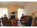 1269 23 Avenue, Didsbury, AB  - Indoor Photo Showing Living Room With Fireplace 