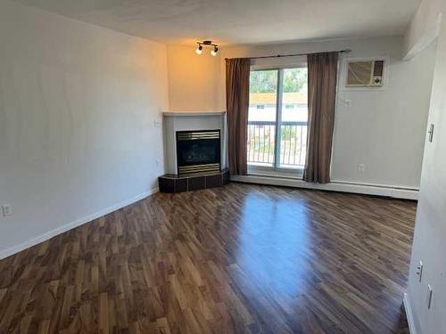 22-398 16 Street Ne, Medicine Hat, AB - Indoor Photo Showing Living Room With Fireplace