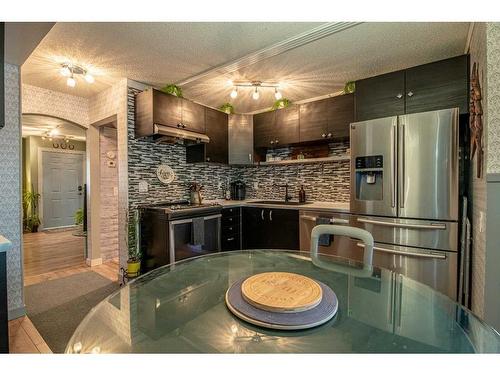 80 Ashwood Road Se, Airdrie, AB - Indoor Photo Showing Kitchen With Stainless Steel Kitchen With Upgraded Kitchen