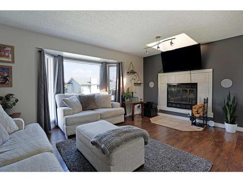 65 Parkland Way East, Brooks, AB - Indoor Photo Showing Living Room With Fireplace