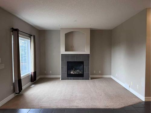 122 Coopers Bay Sw, Airdrie, AB - Indoor Photo Showing Living Room With Fireplace