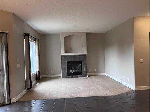 122 Coopers Bay Sw, Airdrie, AB - Indoor Photo Showing Living Room With Fireplace