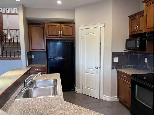 122 Coopers Bay Sw, Airdrie, AB - Indoor Photo Showing Kitchen With Double Sink