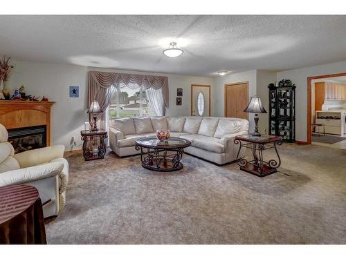 221 13 Street Nw, Drumheller, AB - Indoor Photo Showing Living Room With Fireplace