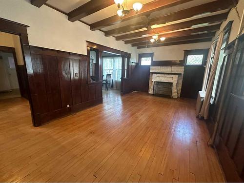 210 4 Avenue East, Hanna, AB - Indoor Photo Showing Other Room With Fireplace