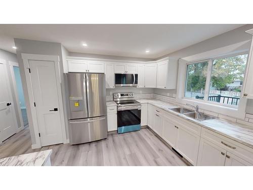 39 Wildrose Crescent, Brooks, AB - Indoor Photo Showing Kitchen With Double Sink