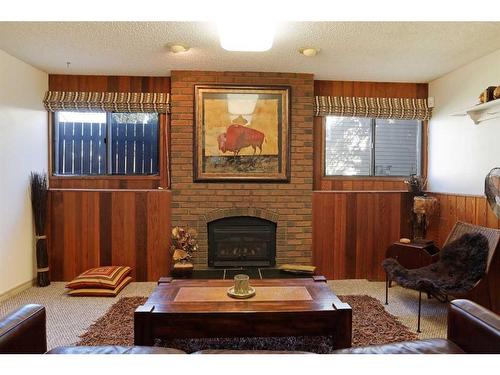 32 Lake Stafford Drive East, Brooks, AB - Indoor Photo Showing Living Room With Fireplace