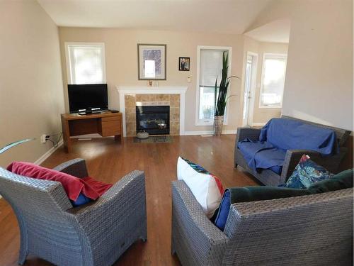 87 Greystone Close East, Brooks, AB - Indoor Photo Showing Living Room With Fireplace