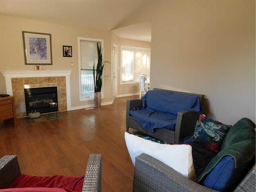 87 Greystone Close East, Brooks, AB - Indoor Photo Showing Living Room With Fireplace