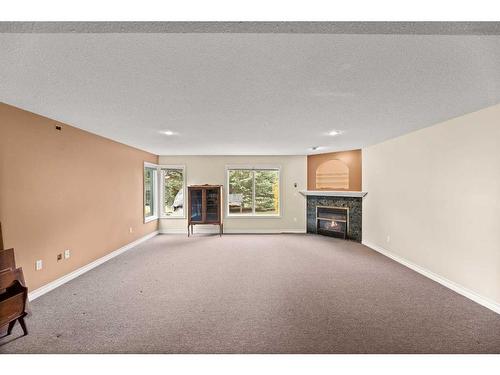 31222 Range Road 20A #16, Rural Mountain View County, AB - Indoor Photo Showing Living Room With Fireplace