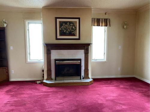 413 9 Street East, Drumheller, AB - Indoor Photo Showing Living Room With Fireplace