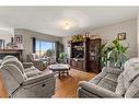 464 Sunset Link, Crossfield, AB  - Indoor Photo Showing Living Room With Fireplace 