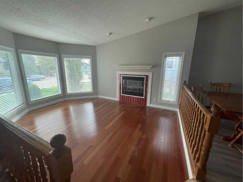 28 Parkland Way East, Brooks, AB - Indoor Photo Showing Living Room With Fireplace