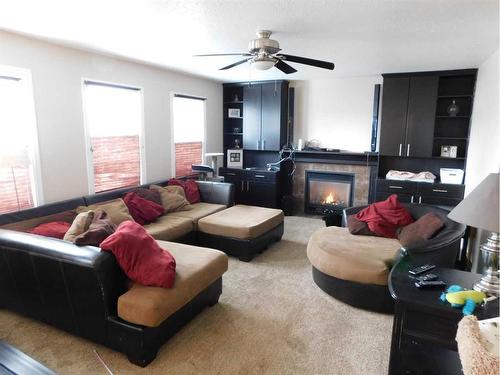 76 Blazier Park Street East, Brooks, AB - Indoor Photo Showing Living Room With Fireplace