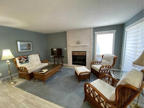 724 2 Street East, Brooks, AB - Indoor Photo Showing Living Room With Fireplace