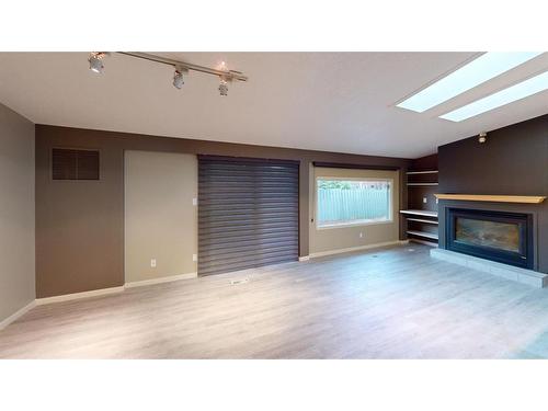 11 Laurel Place, Brooks, AB - Indoor Photo Showing Living Room With Fireplace