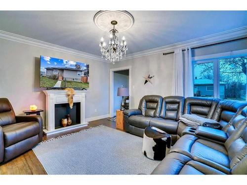 201 4 Avenue West, Hanna, AB - Indoor Photo Showing Living Room With Fireplace