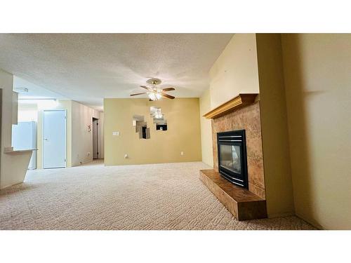 14-830 Birchwood Close, Drumheller, AB - Indoor Photo Showing Living Room With Fireplace