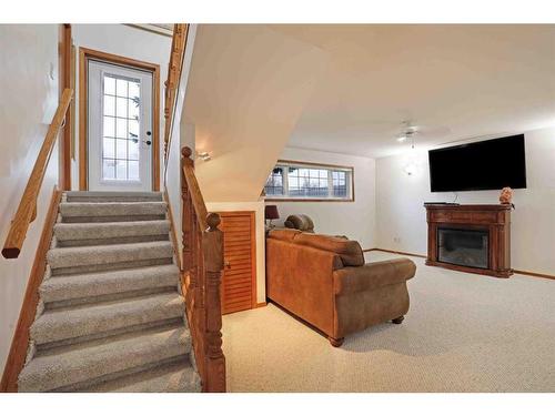 204 2 Avenue East, Hanna, AB - Indoor Photo Showing Other Room With Fireplace