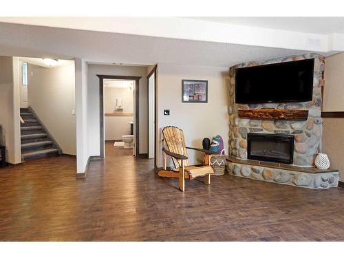 110 Upland Road, Brooks, AB - Indoor Photo Showing Living Room With Fireplace