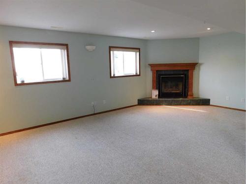 48 Kellington Close, Brooks, AB - Indoor Photo Showing Living Room With Fireplace