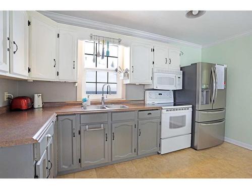 8 Evergreen Park Close West, Brooks, AB - Indoor Photo Showing Kitchen With Double Sink