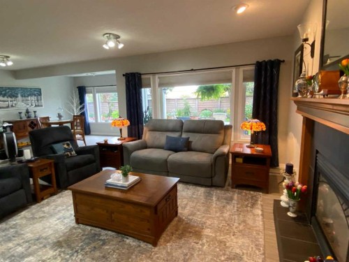 79 Park Place West, Brooks, AB - Indoor Photo Showing Living Room With Fireplace