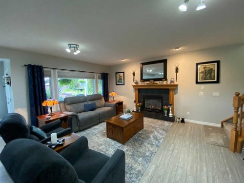79 Park Place West, Brooks, AB - Indoor Photo Showing Living Room With Fireplace