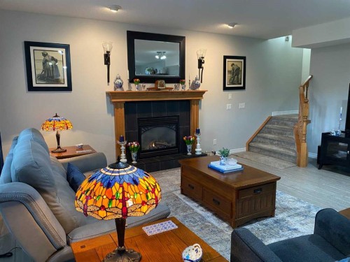 79 Park Place West, Brooks, AB - Indoor Photo Showing Living Room With Fireplace