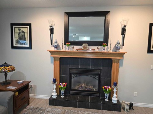 79 Park Place West, Brooks, AB - Indoor Photo Showing Living Room With Fireplace