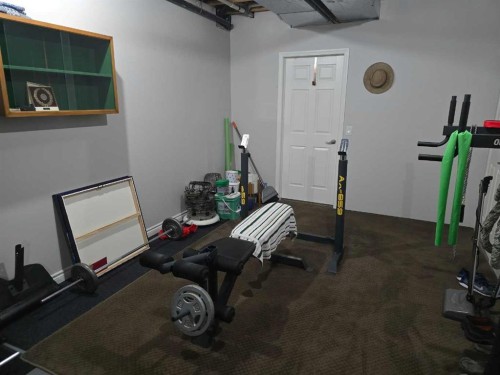 79 Park Place West, Brooks, AB - Indoor Photo Showing Gym Room