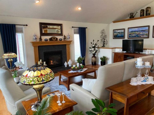 79 Park Place West, Brooks, AB - Indoor Photo Showing Living Room With Fireplace