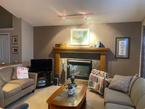 19 Prestwick Green Se, Calgary, AB - Indoor Photo Showing Living Room With Fireplace